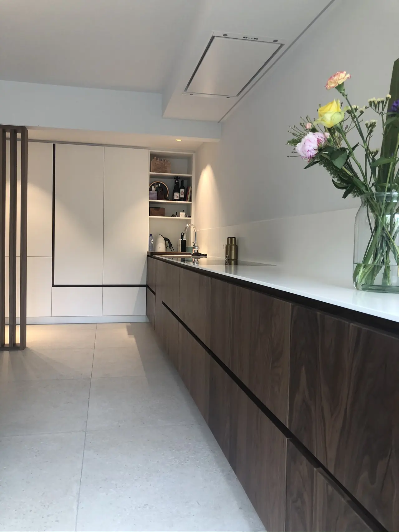 Keukenwand met fronten in notelaar en wit werkblad
